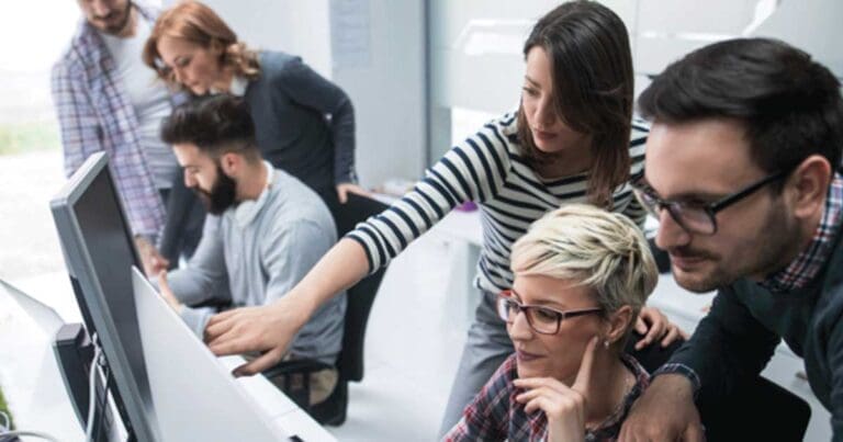 group of people around computers working