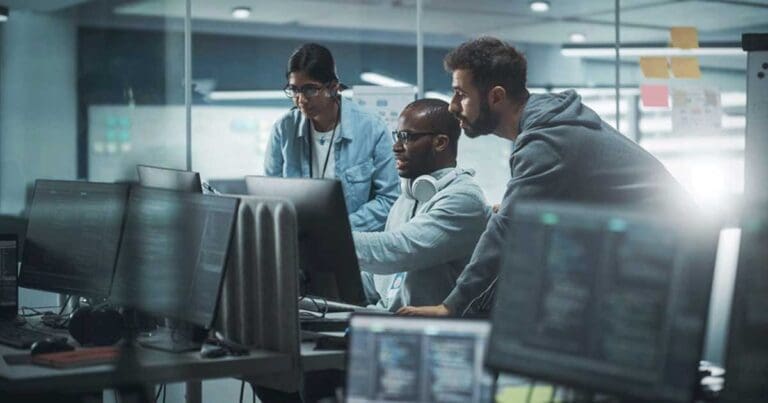 Team at office computer looking at data