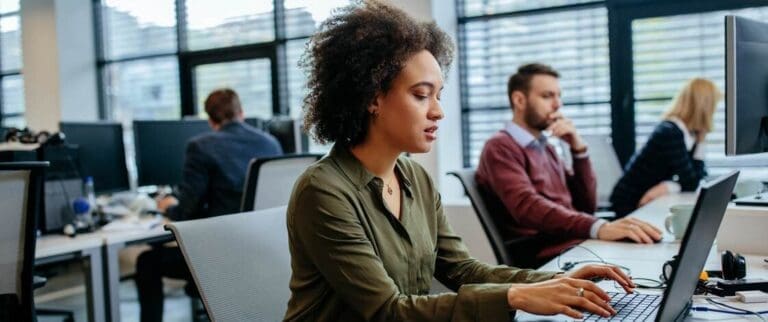 Employee in office working on her laptop