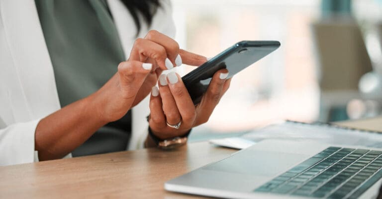 Business woman holding phone using mobile app