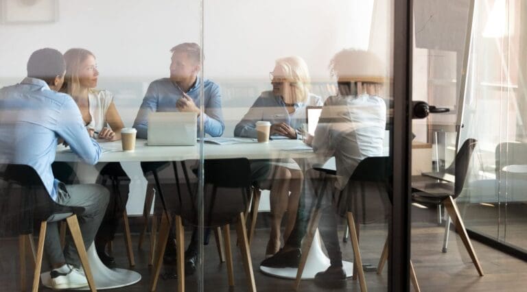Business people negotiating at boardroom behind closed doors